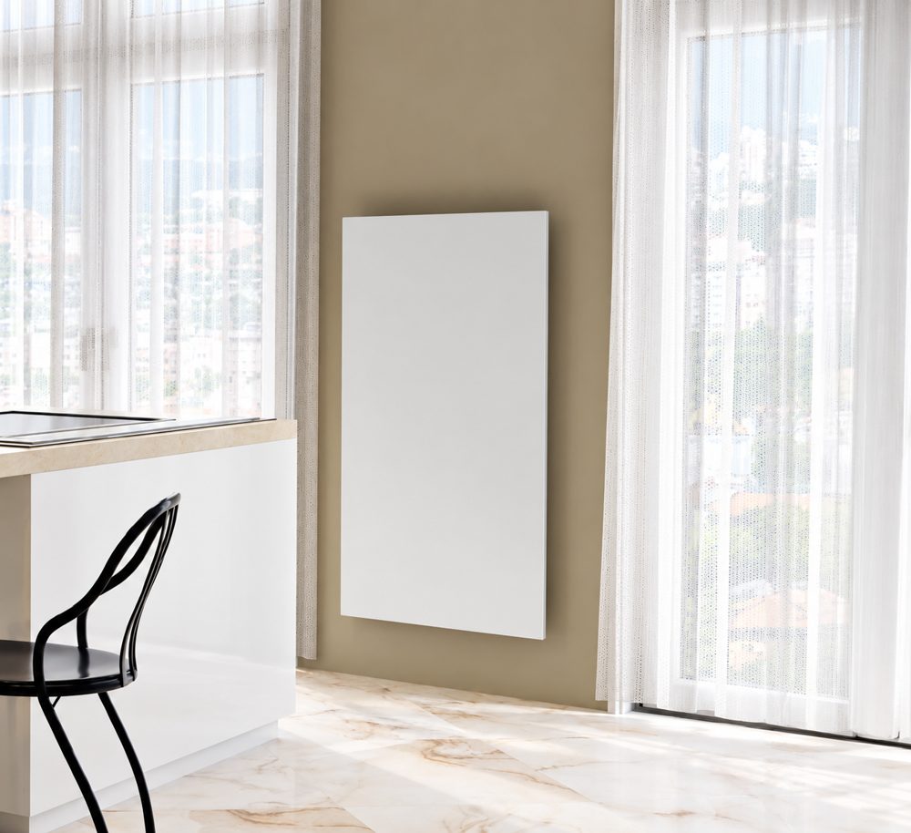 White steel infrared heating panel between two kitchen windows